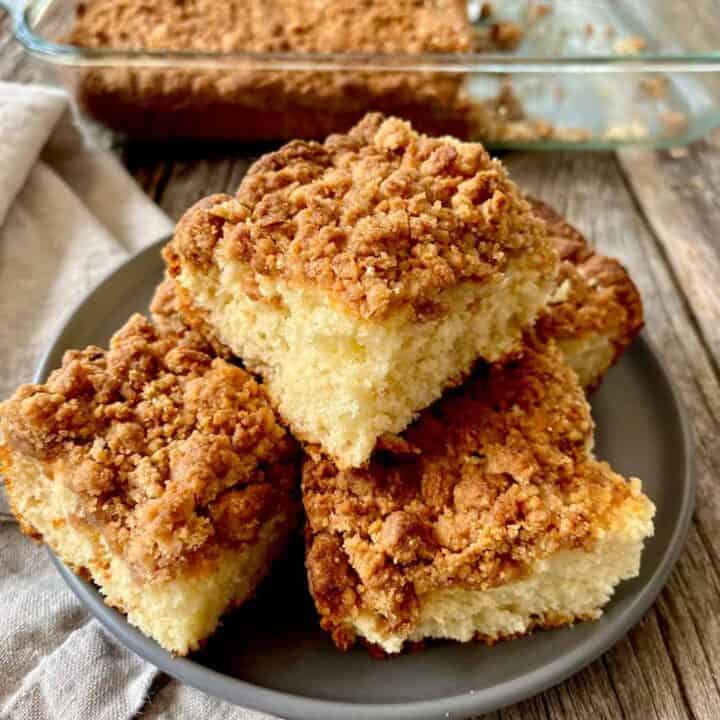 Delicious homemade coffee cake with crumb topping on a gray plate.