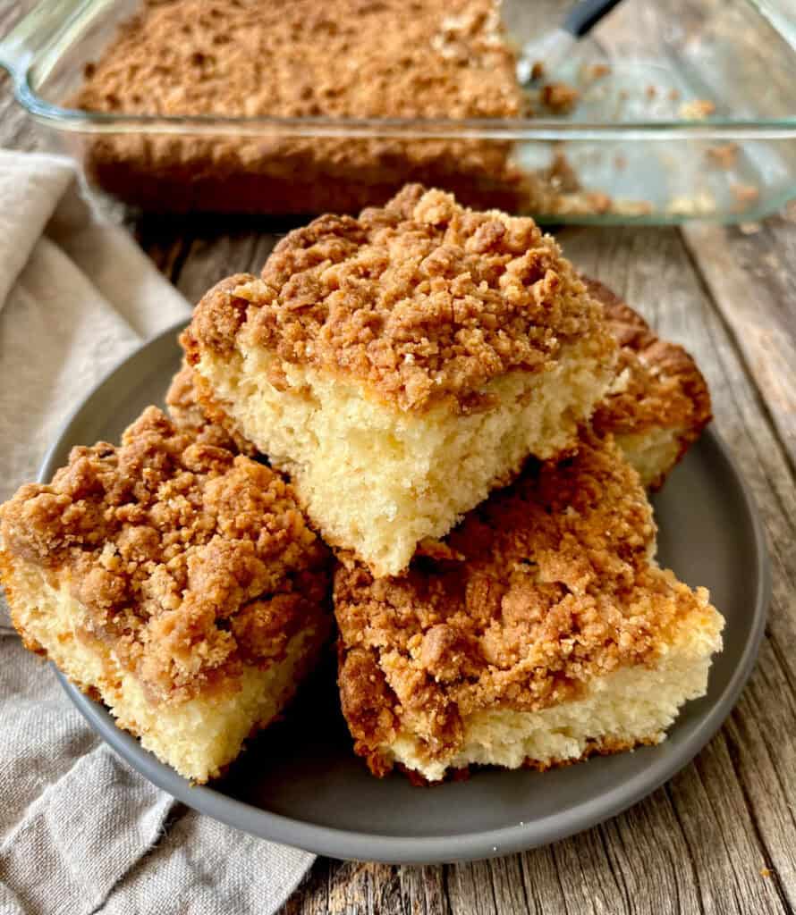 Delicious homemade coffee cake with crumb topping on a gray plate.