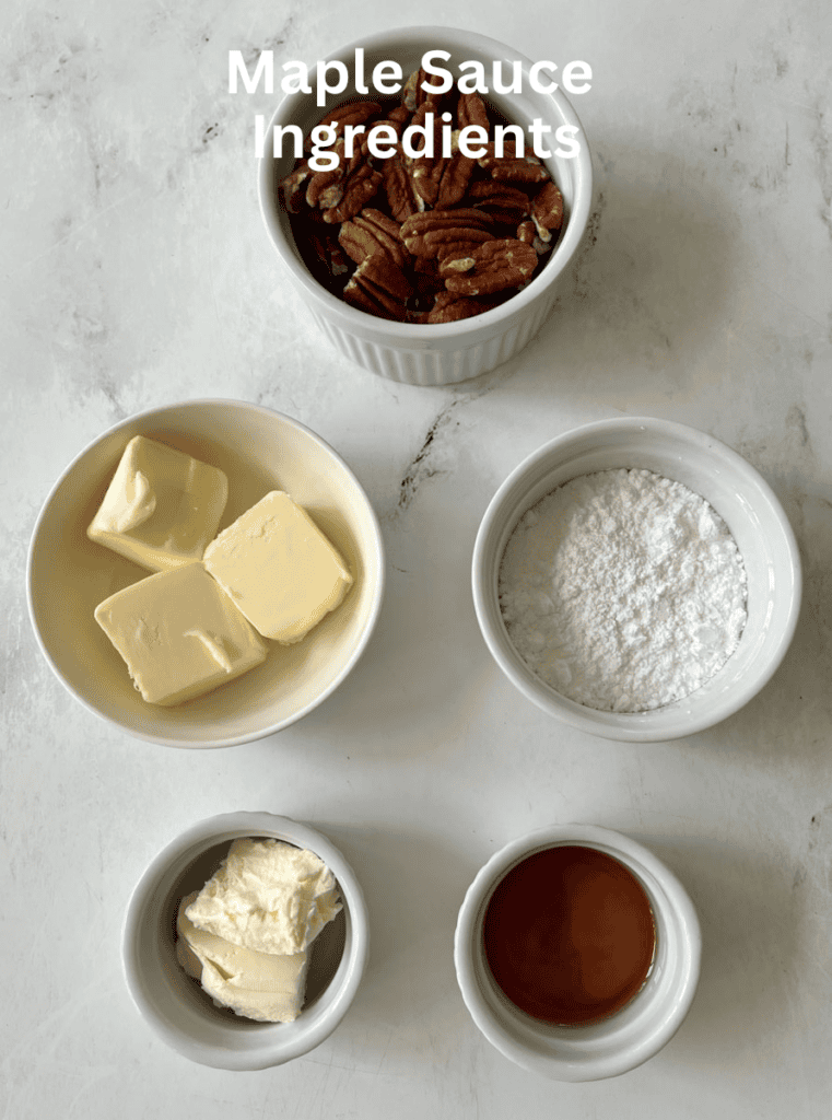 Maple sauce ingredients including pecans, butter, sugar, powdered sugar, cream cheese, and syrup.
